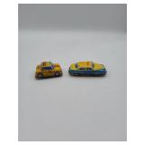 Two Yellow Tin Taxi Toys