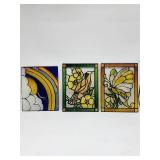 Three stained glass panels with rainbow, bird, and
