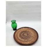 Green glass vase with brown ceramic platter