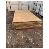 Mixed bundle of OSB and T1-11 4' x 8' sheets.