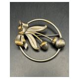 vintage floral brooch featuring a circular frame