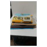 An Assortment Of Records And An 8 Track Tape