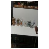 Assortment of Beer Steins And Naked Wood Lady