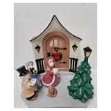 Glass Carolers In Front Of Door Display