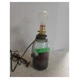 Glass Bottle Lamp Inside With Dried Red Flowers