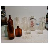 Assorted Milk Bottles And Colored Glass Bottles