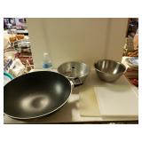 Wok, Mixing Bowl And Bundt Cake Pan And Cutting