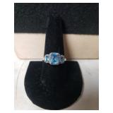 Ladies 10K White Gold Ring W/Light Blue Stones -