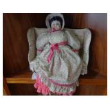 Doll with floral dress and mini doll couch