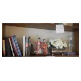 shelf lot of books, oriental figurines, candle