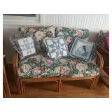 Rattan couch with decorative pillows
