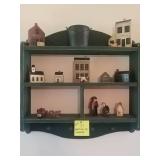 Green shelf with contents
(Screwed into wall.