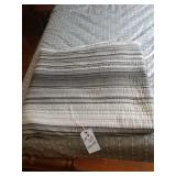 White grey and black striped quilt