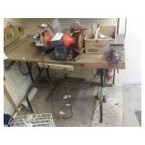 Table with electric grinder, vice grip and