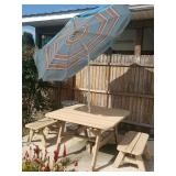 Wooden picnic table with two small benches and