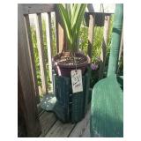 Green wooden watering can stand with plant