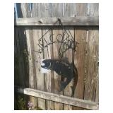 Metal welcome sign with hanging fish