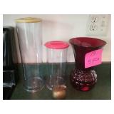 Container and red vase and apple