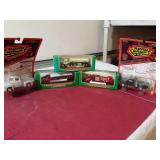 3 miniature Hess trucks and two die- cast metal