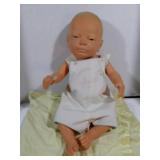 Baby doll with yellow  blanket