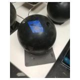 Black bowling ball w/ stand. Weight unknown. Has