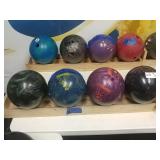 4 bowling balls with wooden rack