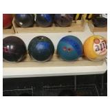 4 bowling balls with wooden rack