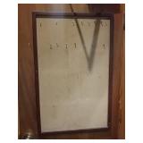 Cork board. Screwed into wall. Bring your own