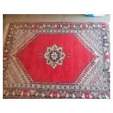 Red patterned area rug 49" x 65"