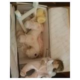 Porcelain baby doll with rocking horse