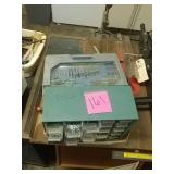 Bin with contents and drill bits