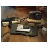 3 old cameras with cases