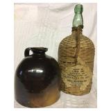 Old crockery jug and wicker covered wine bottle