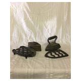 Two old irons and two trivets