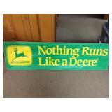 John Deere paper sign stapled to a wood frame