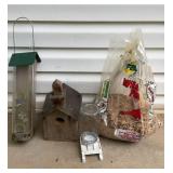 Two birdfeeders one plastic and metal, one wood