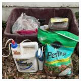 Tote full of garden care supplies.