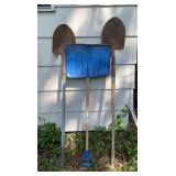 Three shovels. Blue snow shovel has a few places