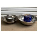 Three metal mixing bowls and an old cookie tin