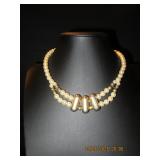 Faux pearl necklace with gold tone accents