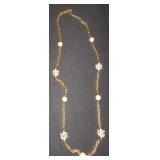 gold chain with white balls and clear cluster