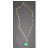gold chain with green heart