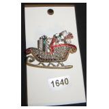 sleight brooch with presents