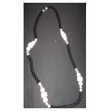 black and white bead necklace with gold accents