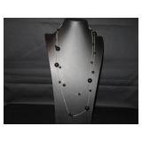 Really long silver tone necklace with black beads