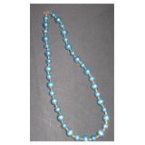 blue bead necklace with gold accents