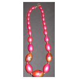 Pink bead necklace with leaves painted on it