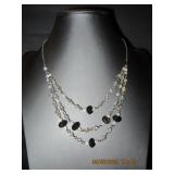 Silver tone triple strand clear & black beads