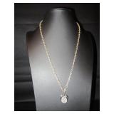 Gold tone necklace with a heart hanging