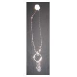 long silver chain with circle pendent